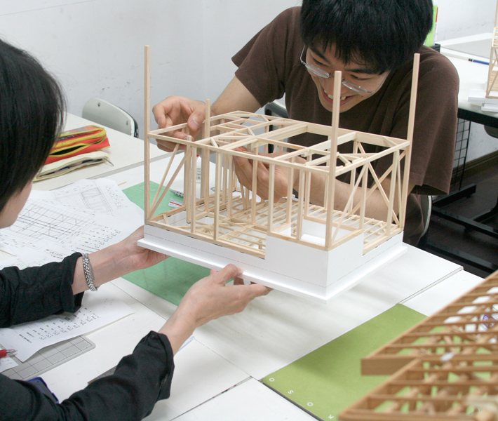 木造の構造を知るために軸組模型制作の授業。手書きの図面もたくさん描いて、設計事務所で通用する技術を身につけます。